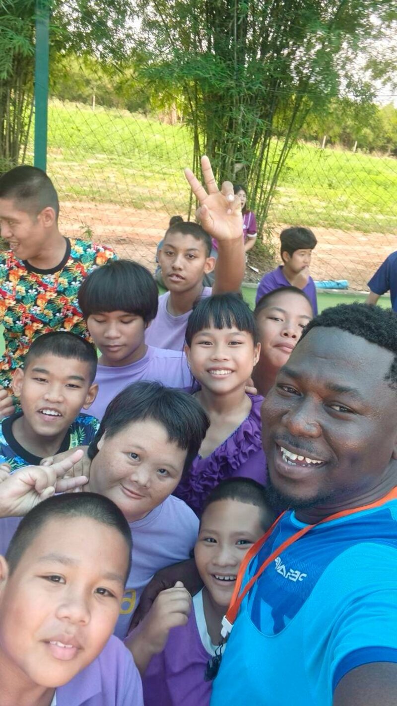 Coach Abbas with smiling players at Ban Kru Boonchu